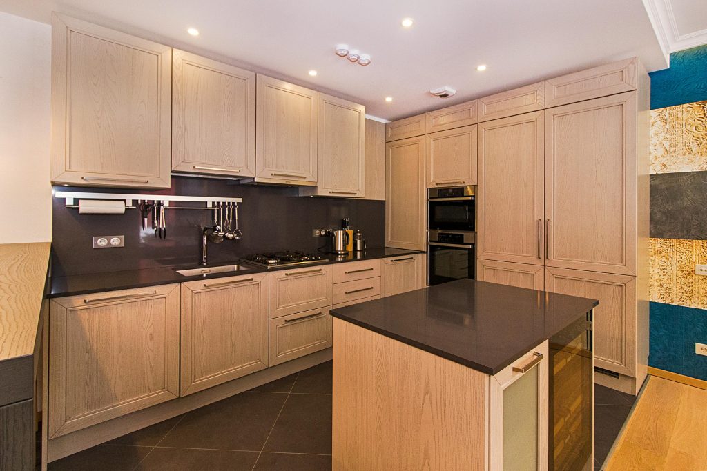 Contemporary kitchen with wooden cabinetry and a sleek island.
